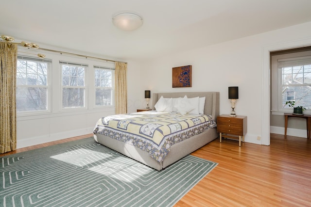 bedroom featuring hardwood / wood-style floors and multiple windows