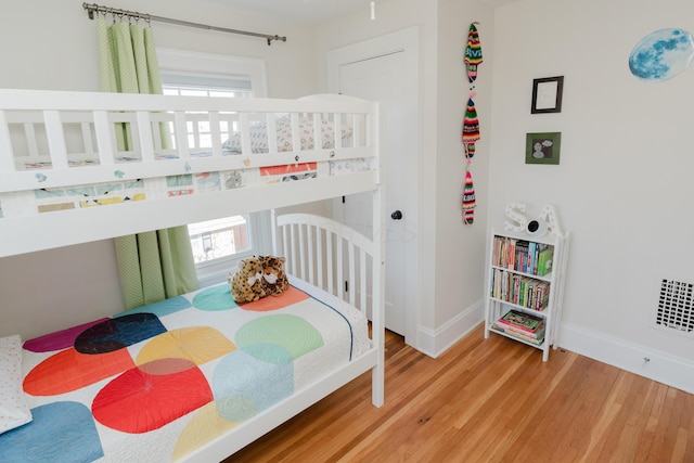 bedroom with wood-type flooring