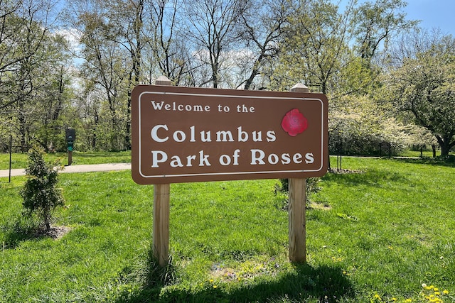 community sign featuring a lawn