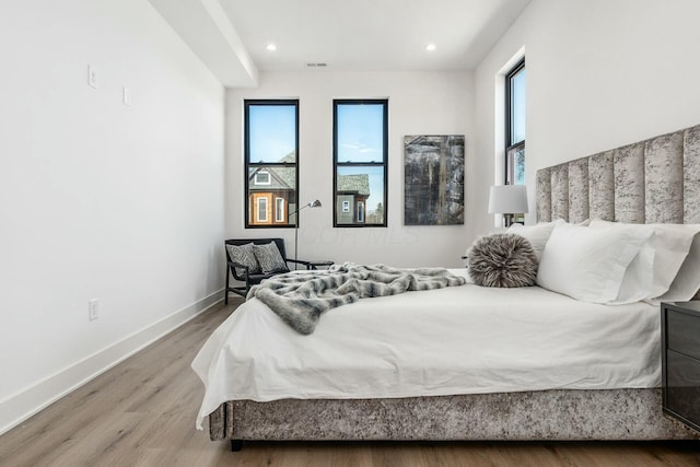 bedroom with hardwood / wood-style floors