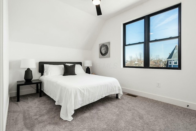 bedroom with ceiling fan, lofted ceiling, and carpet floors