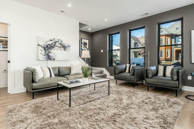 living room featuring wood-type flooring and plenty of natural light