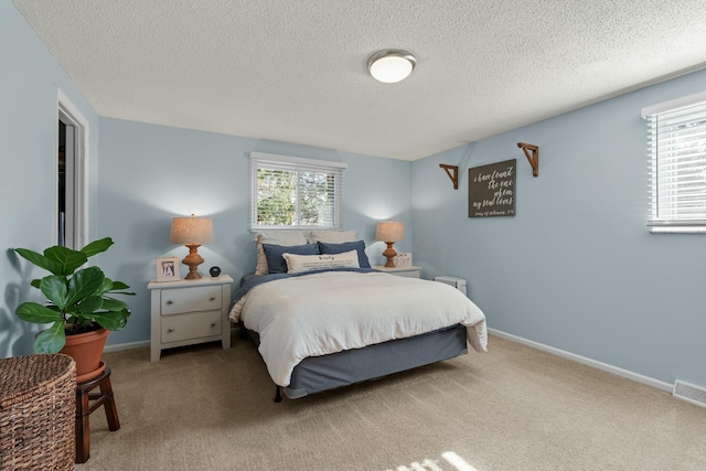 bedroom featuring multiple windows, carpet, and baseboards