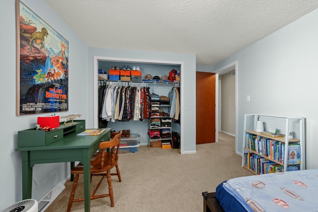 bedroom featuring light carpet, a textured ceiling, baseboards, and a closet