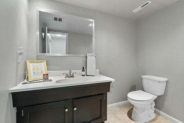 bathroom featuring toilet, baseboards, visible vents, and vanity