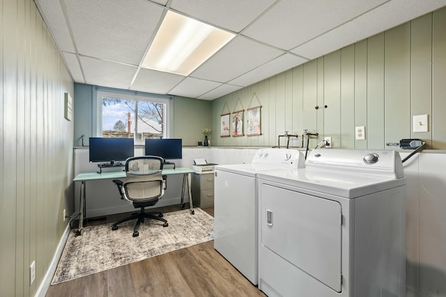 laundry room with washing machine and dryer, laundry area, and wood finished floors