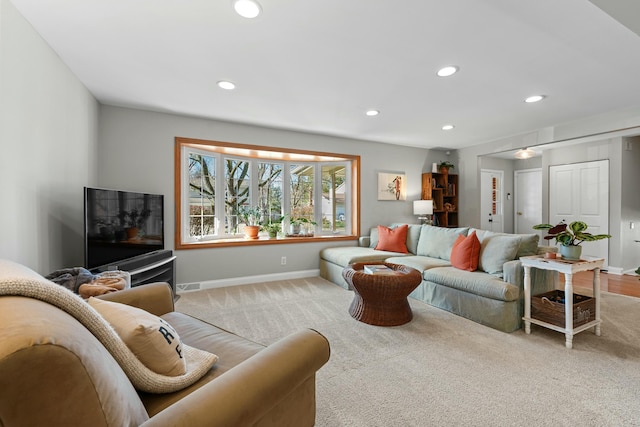 carpeted living room featuring visible vents, baseboards, and recessed lighting