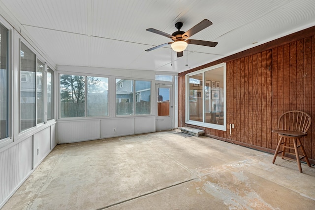 unfurnished sunroom with a ceiling fan