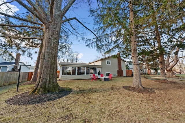 back of house with a yard and fence