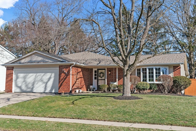 ranch-style house featuring a garage, brick siding, and a front yard