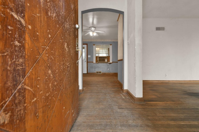 hallway featuring dark hardwood / wood-style flooring, cooling unit, and ornamental molding