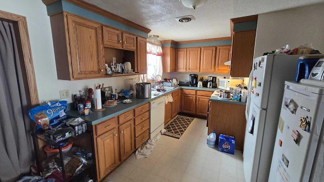 kitchen featuring white appliances and a textured ceiling