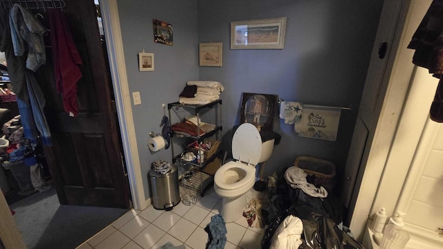 bathroom with toilet and tile patterned flooring