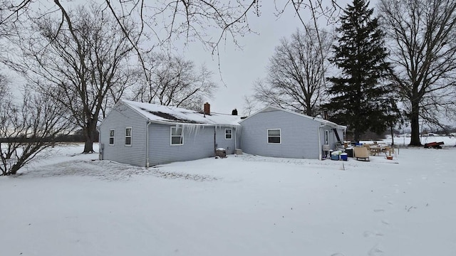 view of snow covered back of property