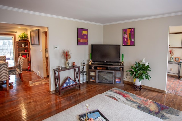 living room featuring hardwood / wood-style flooring and crown molding