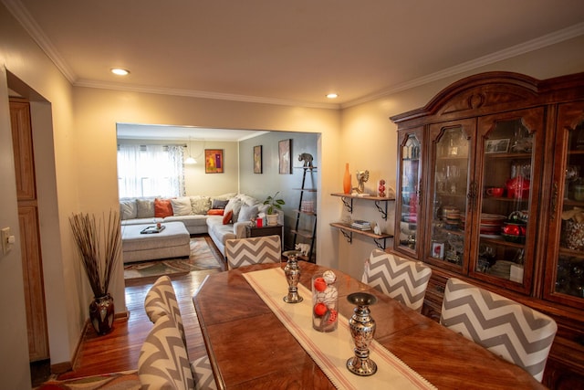 dining area featuring ornamental molding and dark hardwood / wood-style flooring