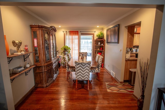 dining room with crown molding and dark hardwood / wood-style floors