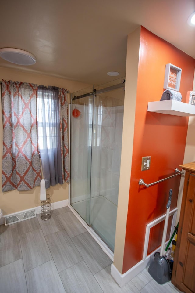 bathroom featuring an enclosed shower