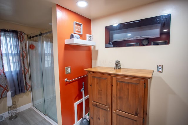 bathroom featuring an enclosed shower