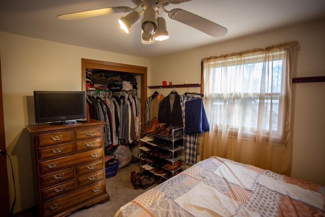 carpeted bedroom with ceiling fan and a closet