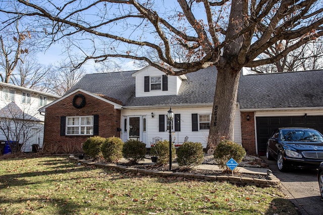 view of front of house featuring a garage and a front lawn