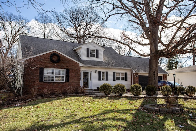 cape cod-style house featuring a garage and a front yard