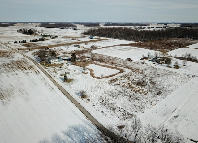 snowy aerial view featuring a rural view