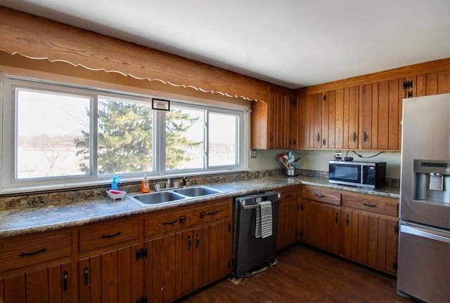 kitchen featuring stainless steel appliances, sink, and dark hardwood / wood-style floors