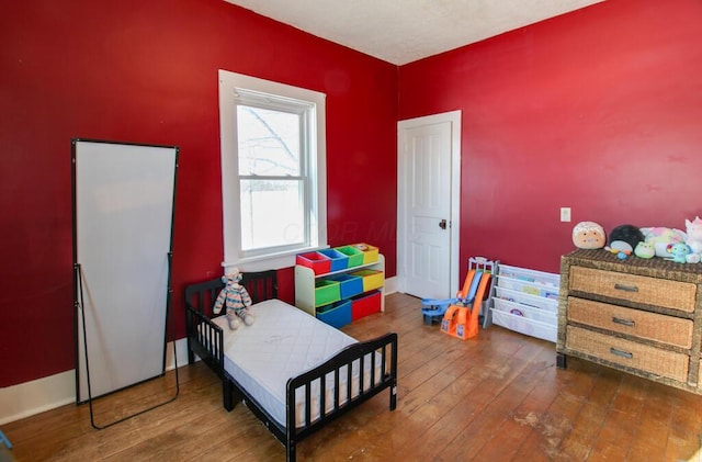 bedroom with dark wood-type flooring