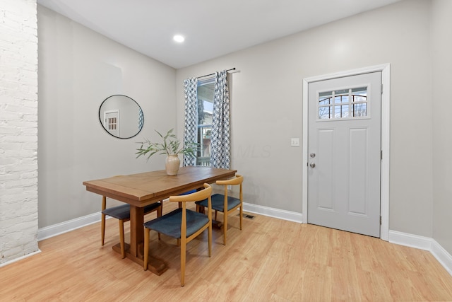 dining space featuring light wood-type flooring