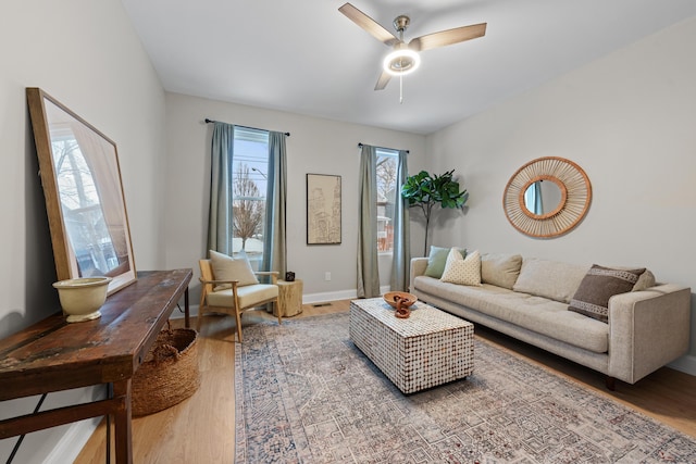 living room featuring hardwood / wood-style floors and ceiling fan