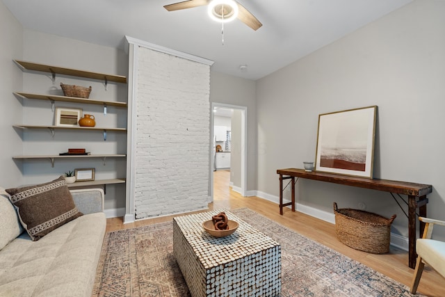 living room featuring light hardwood / wood-style floors and ceiling fan