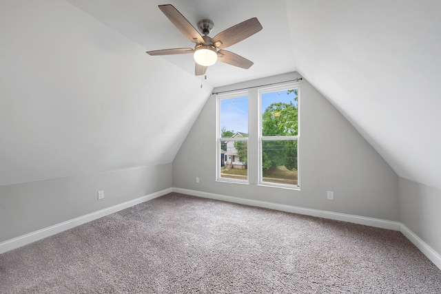 additional living space with vaulted ceiling, carpet floors, and ceiling fan