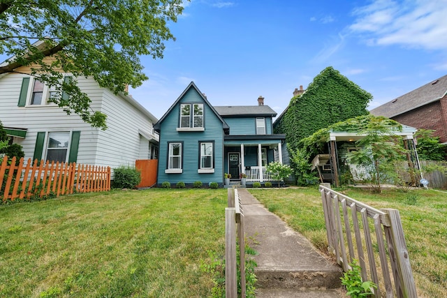 view of front of home with a front yard and a porch