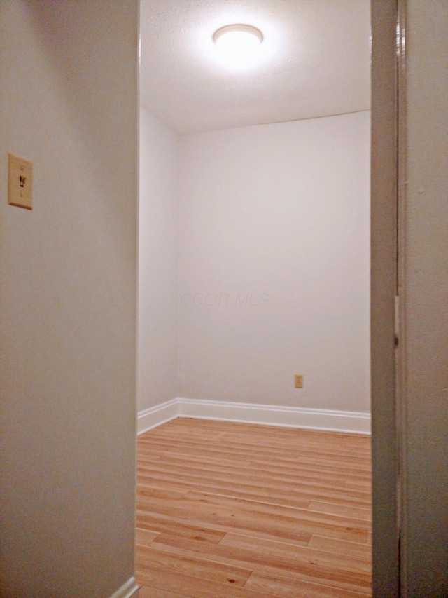 empty room with hardwood / wood-style flooring