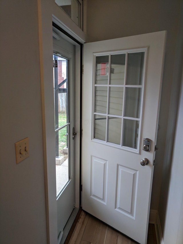 doorway to outside with wood-type flooring