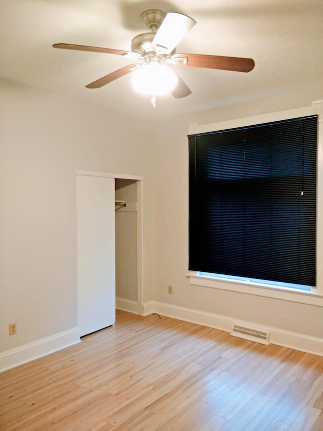 interior space with ceiling fan, light hardwood / wood-style floors, and a closet