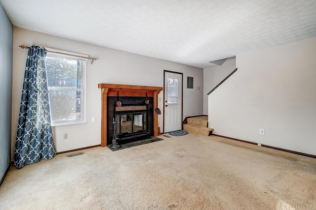 carpeted living room with a textured ceiling