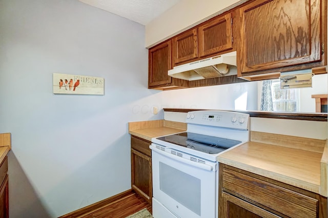 kitchen with white electric range oven and a textured ceiling