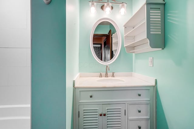 bathroom with vanity and a tub