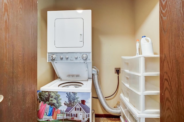 clothes washing area featuring stacked washer / dryer