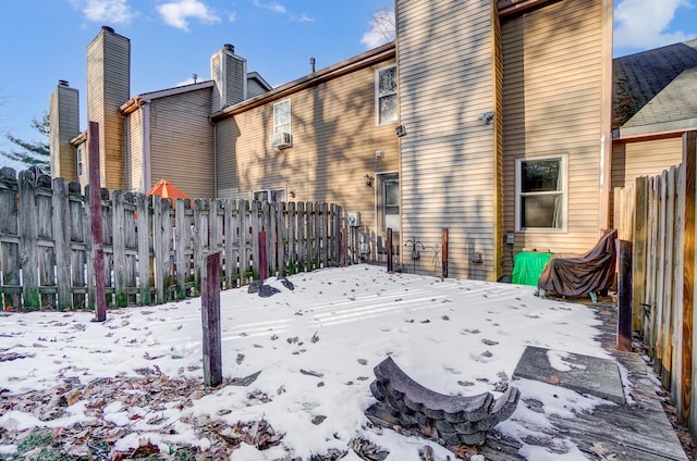 view of snow covered rear of property