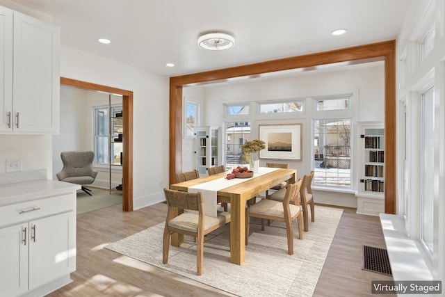 dining area featuring light wood-type flooring