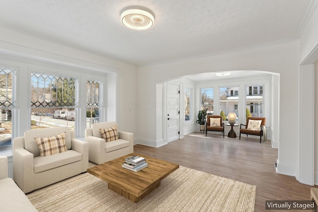 living room with ornamental molding and light wood-type flooring