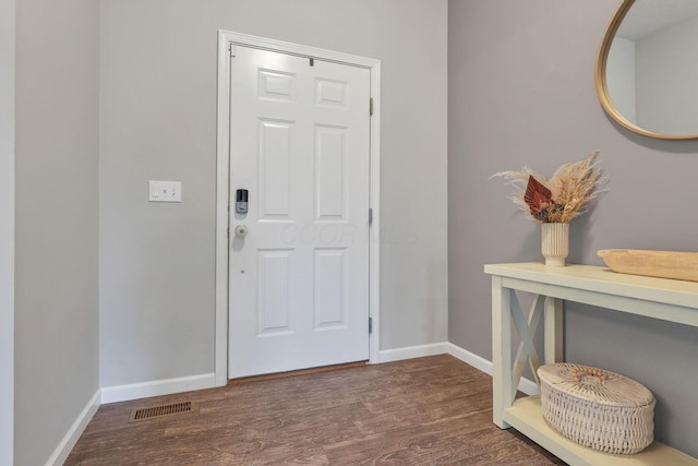 foyer entrance featuring dark wood-type flooring