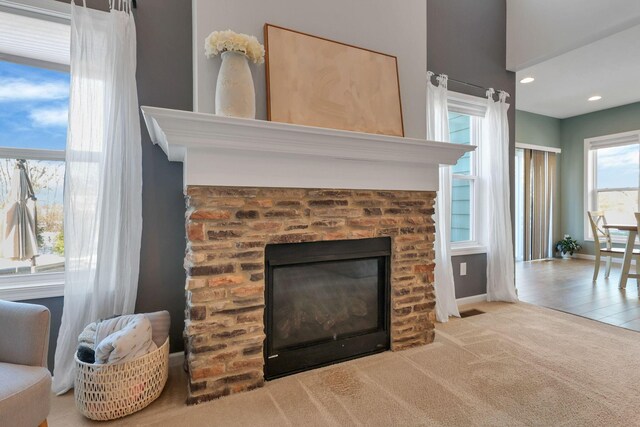 interior details featuring carpet and a brick fireplace