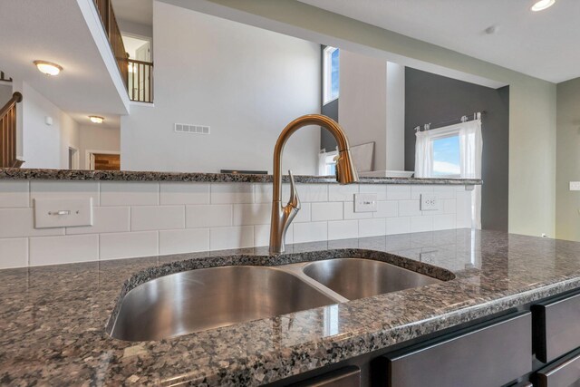 interior details featuring sink and dark stone counters