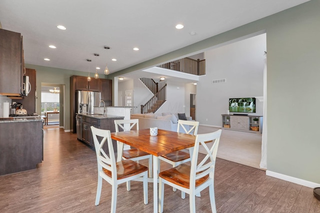 dining room with dark hardwood / wood-style flooring and sink