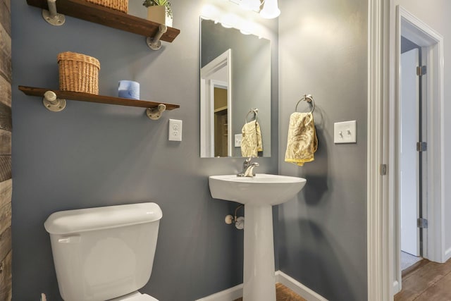 bathroom with toilet and hardwood / wood-style floors