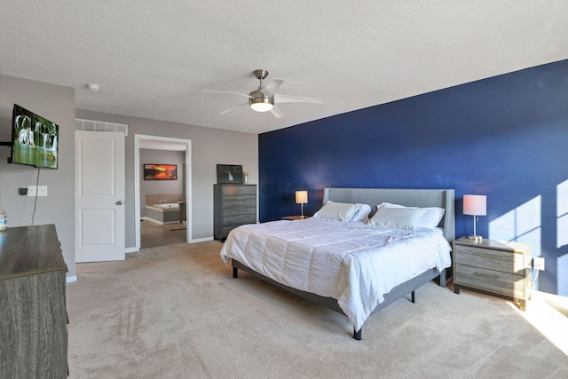 carpeted bedroom featuring a textured ceiling and ceiling fan